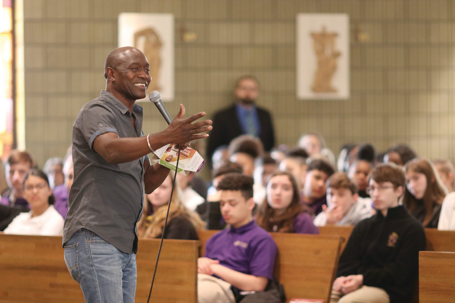 Thomas Awiapo speaks to students at St. Raphael Academy about his experiences growing up as an orphan in Ghana in which he was rescued from extreme hunger through his participation in an education initiative sponsored through the CRS Rice Bowl program.